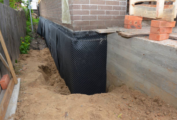 Happy homeowners after waterproofing job in Jones